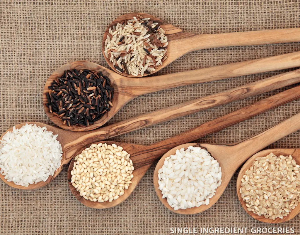 different types of rice in spoons 