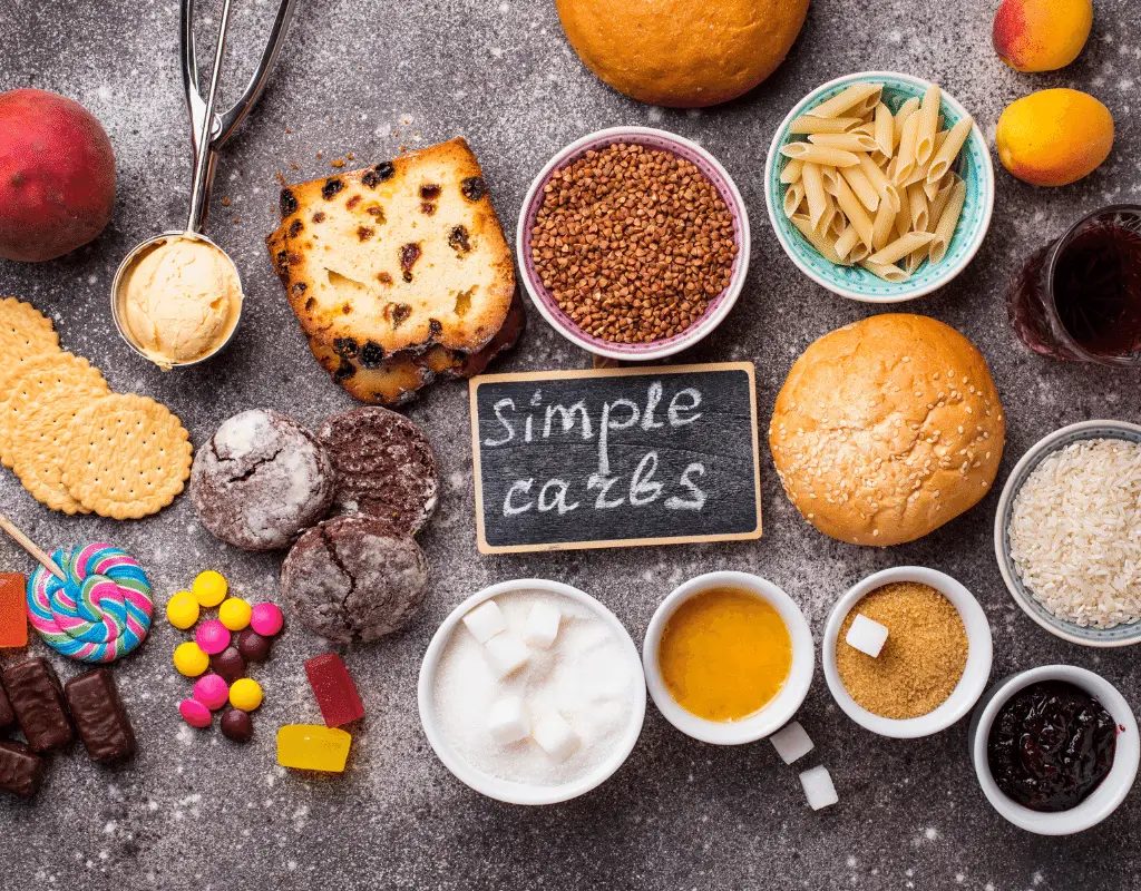 simple carbs foods displayed on a table: sugar, candy, bread, pasta, rice