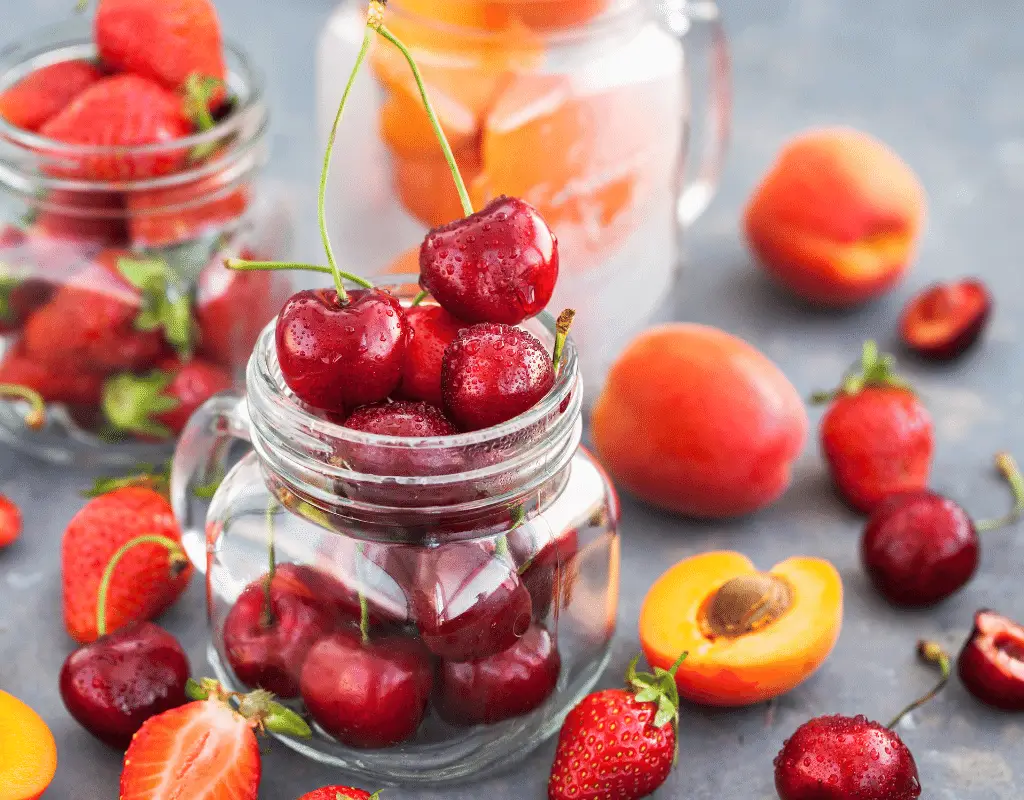 cherries and strawberries in a clear jar