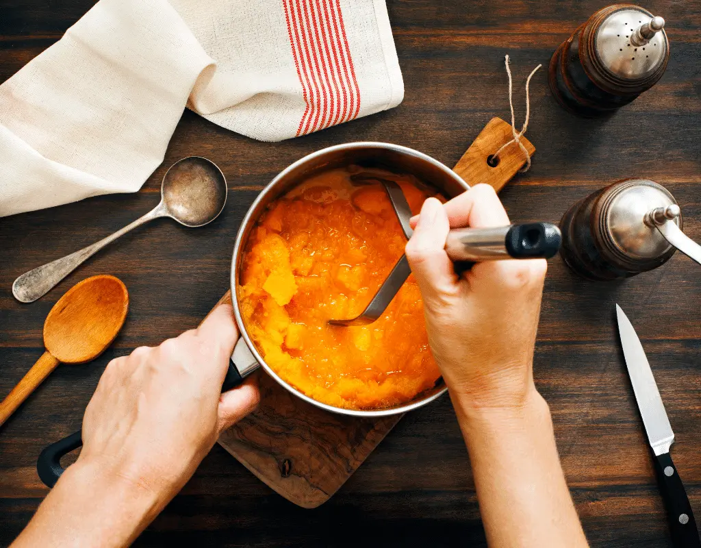 making pumpkin puree in pot with hand mixer